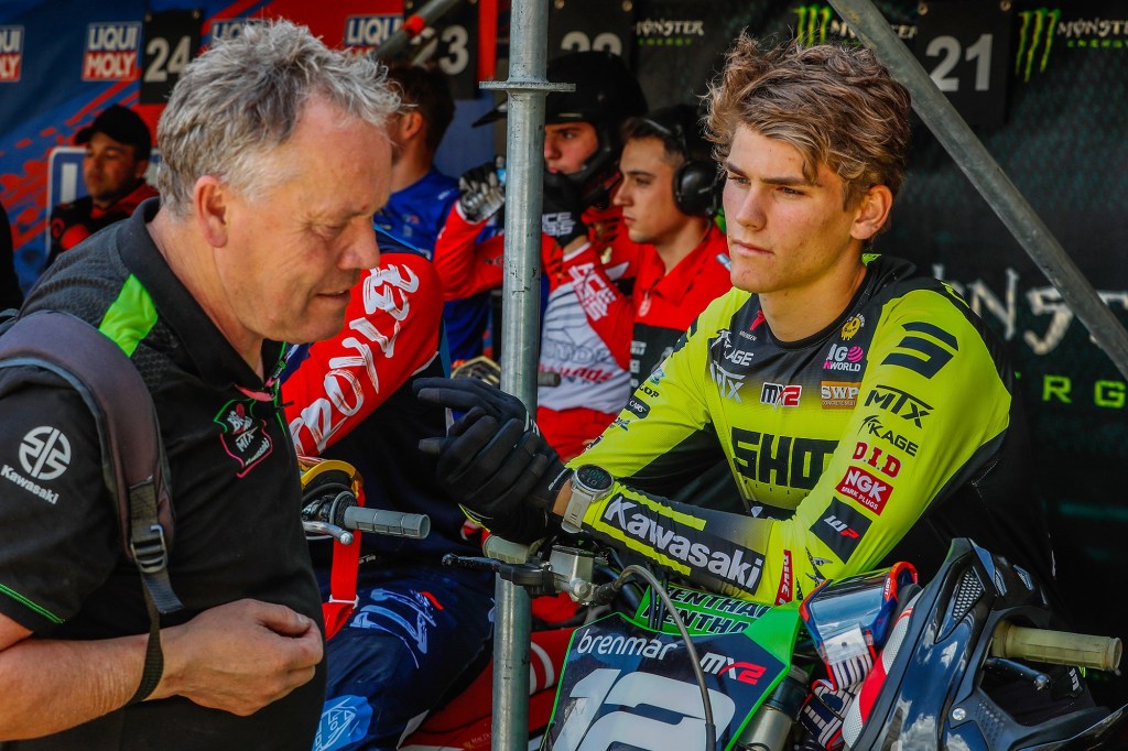 Jack Chambers sitting on his bike with Steve Dixon, before an MX2 race